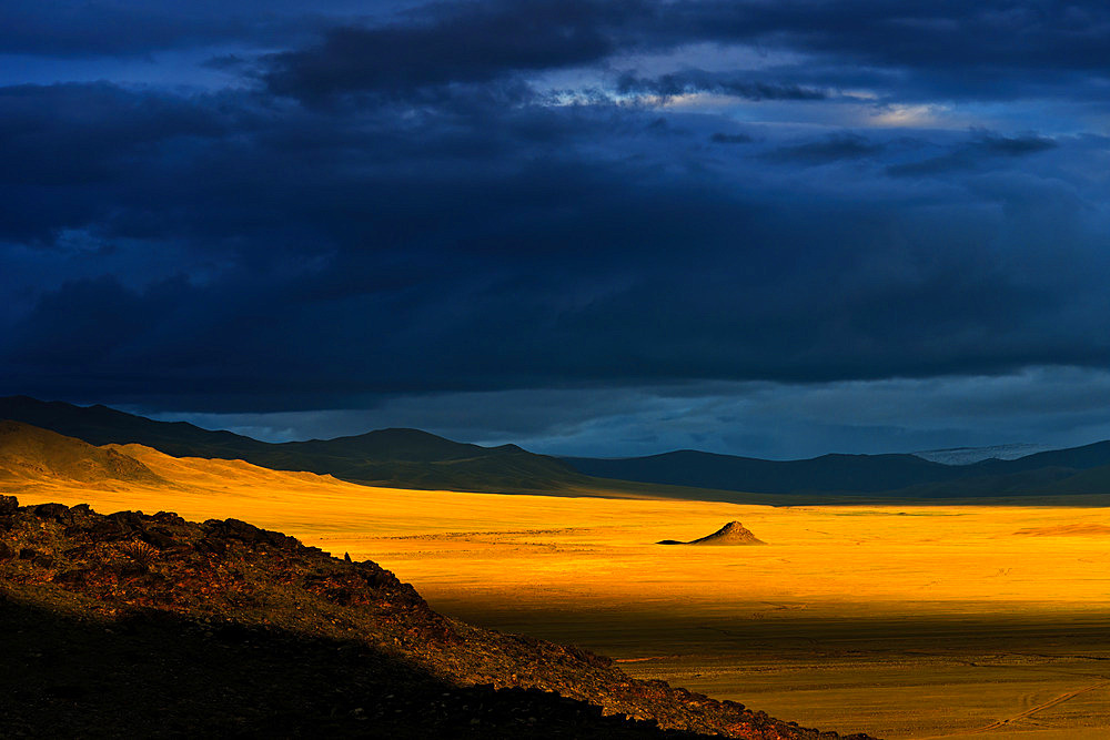 Desolate landscape under an ominous sky in Western Mongolia, near Uureg Lake, Mongolia