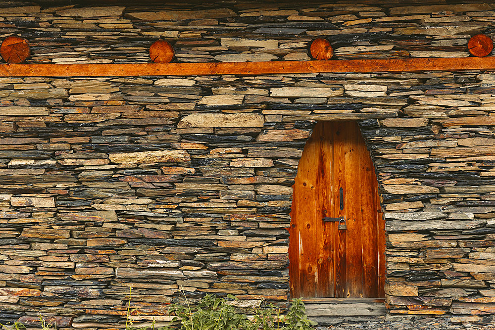 Wooden door with lock on historic stone house in the village of Dartlo in Tusheti National Park, Dartlo, Kakheti, Georgia