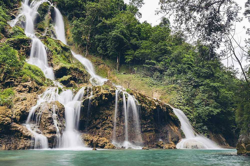 Beautiful cascading series of waterfalls (Lapopu Waterfall) flowing down a hillside on the island of Sumba, East Nusa Tenggara, Indonesia, Katikutana Selatan, Central Sumba Regency, East Nusa Tenggara, Indonesia