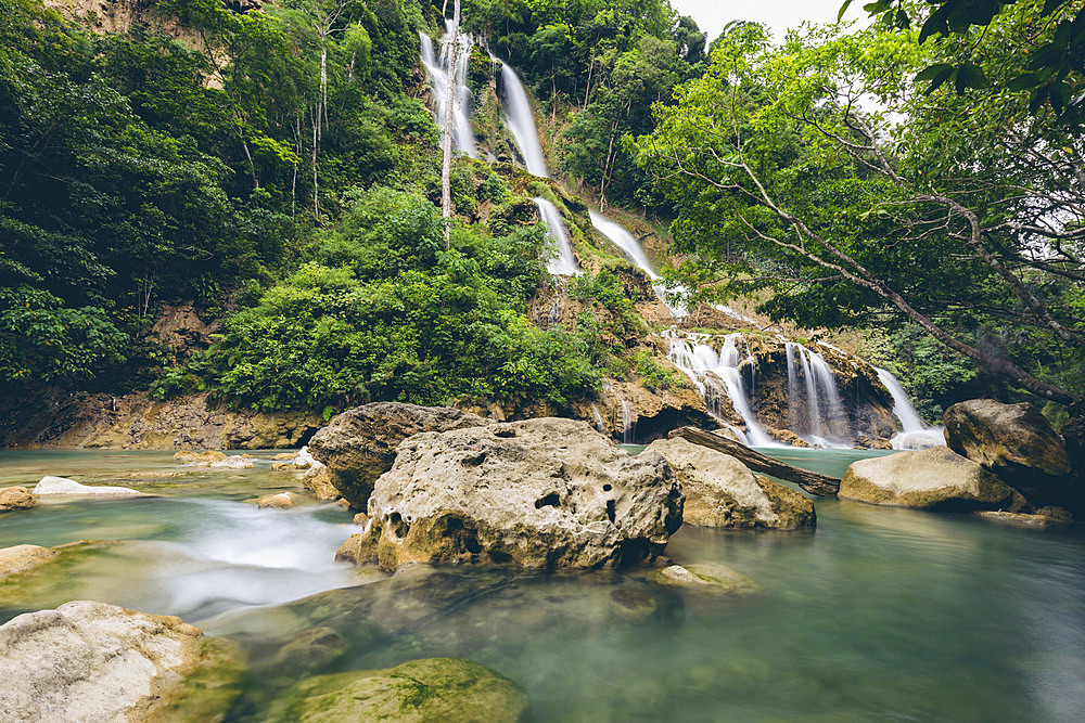 Beautiful cascading series of waterfalls (Lapopu Waterfall) flowing down a hillside on the island of Sumba, East Nusa Tenggara, Indonesia, Katikutana Selatan, Central Sumba Regency, East Nusa Tenggara, Indonesia