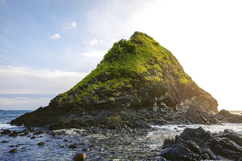 Peaked landforms and sunset light along a rugged Indonesian island at Telawas Beach, Mekar Sari, Praya Barat, Central Lombok Regency, West Nusa Tenggara, Indonesia