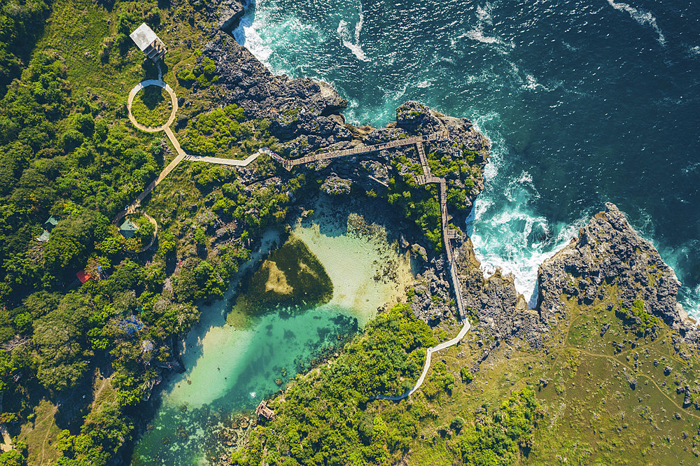 Aerial view of Lake Walakari and trail over the rugged coastline at Nusa Tenggara Timur, Indonesia, Watumbaka, Kecamatan Pandawai, Kabupaten Sumba Timur, Nusa Tenggara Timur, Indonesia