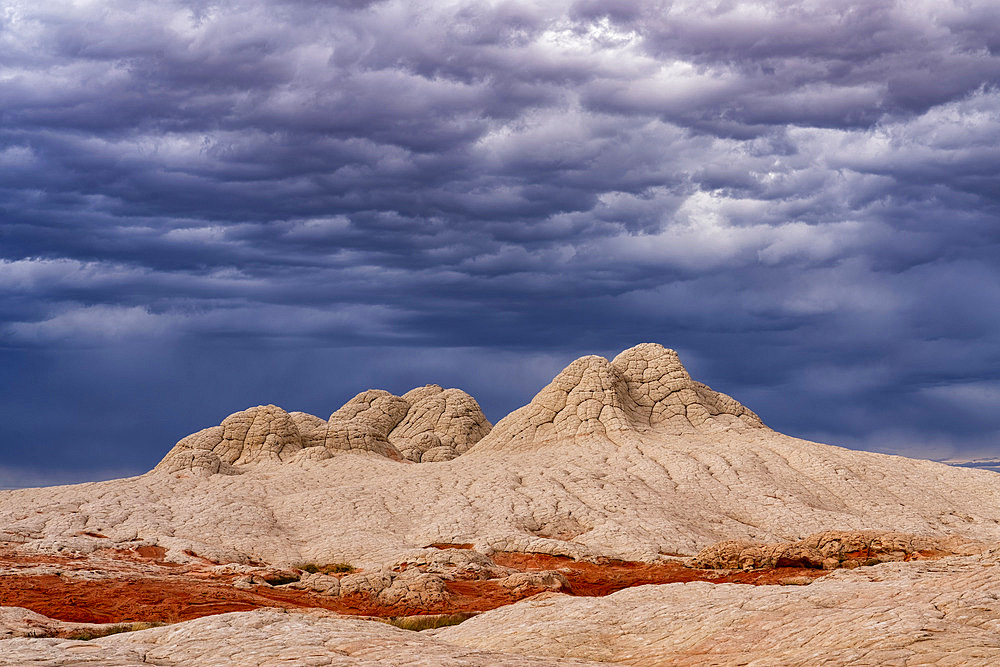 View of geometric patterns on rocky hills referred to as Brain Rocks, against a cloudy sky forming part of the alien landscape of amazing lines, contours and shapes in the wondrous area known as White Pocket, situated in Arizona, Arizona, United States of America