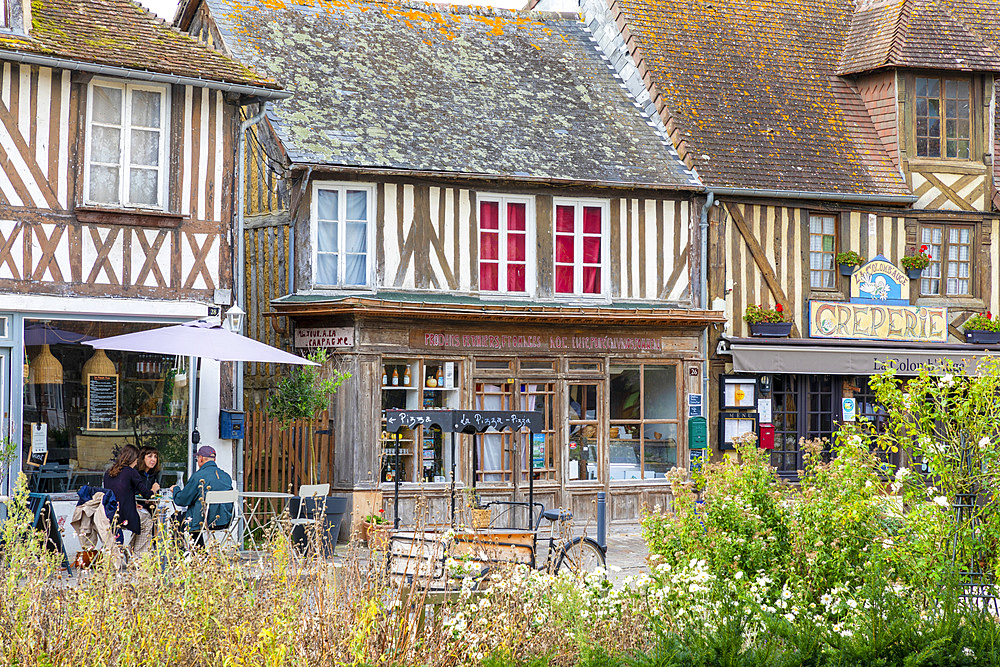 Tourists sitting at cafe in the Normandy village of Beuvron-en-Auge, Beuvron-en-Auge, Normandy, France, Europe