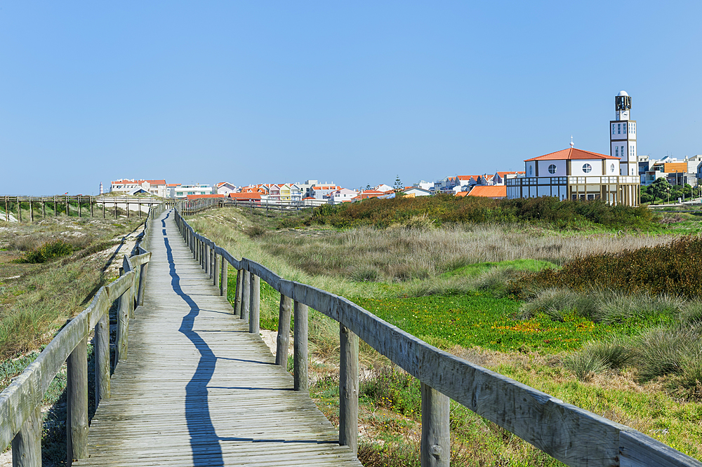 Wooden footpath at Costa Nova Beach, Costa Nova Church behind, Aveiro, Venice of Portugal, Beira Littoral, Portugal, Europe