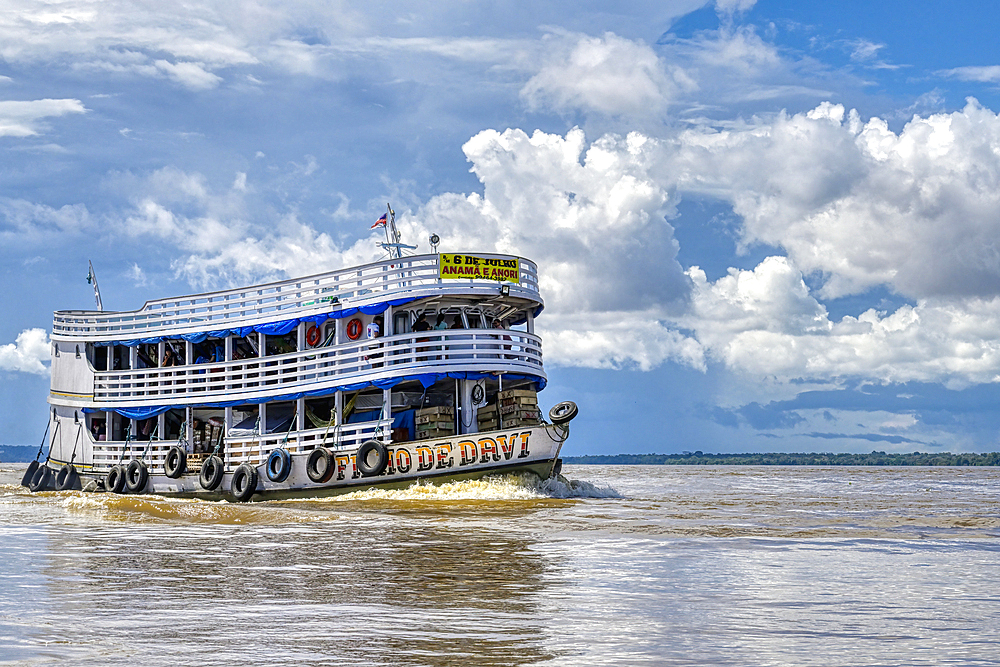 Traditional wooden boat navigating on the Rio Negro, Manaus, Amazonia State, Brazil, South America