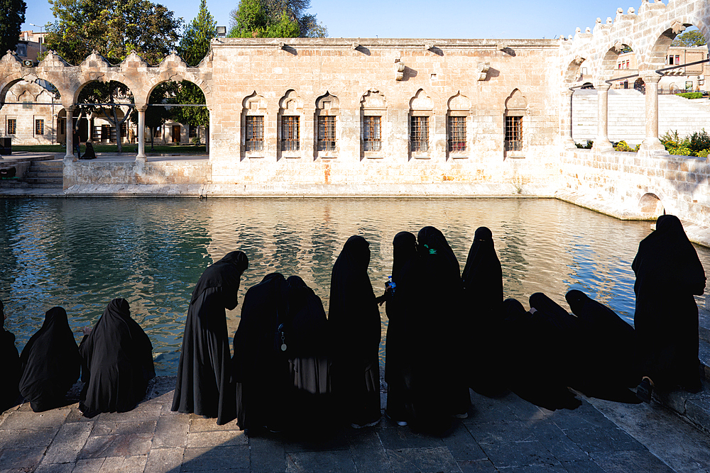 Muslim women wearing abaya in front of Abraham's Pool where the prophet was thrown into fire by King Nimrod, Sanliurfa, Turkey, Asia Minor, Asia