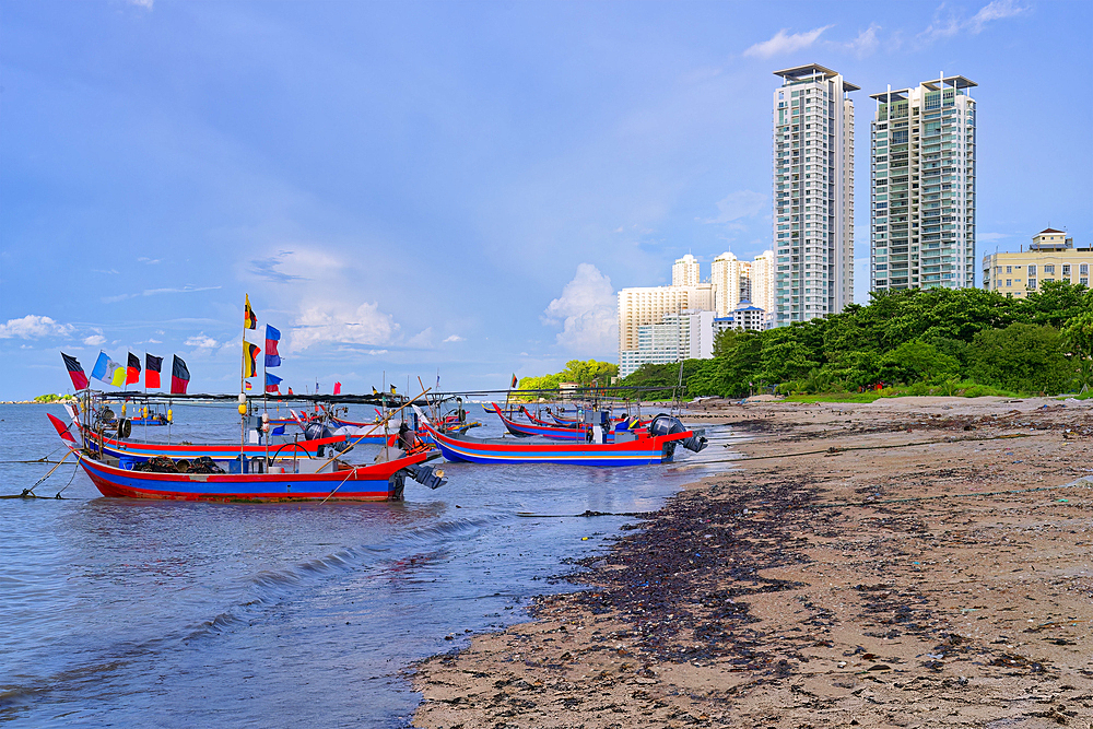 Fishing boats and George Town skyline along the Malacca Strait near Penang Floating Mosque, Penang, Malaisia