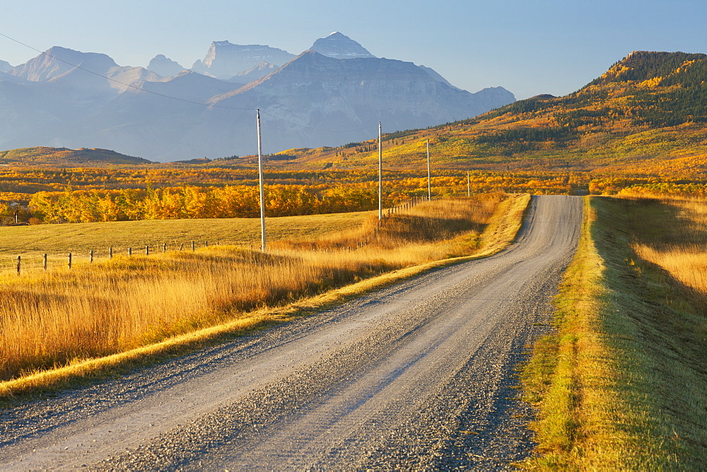 Country road through a mountainous landscape, near Twin Butte, Alberta, Canada, North America