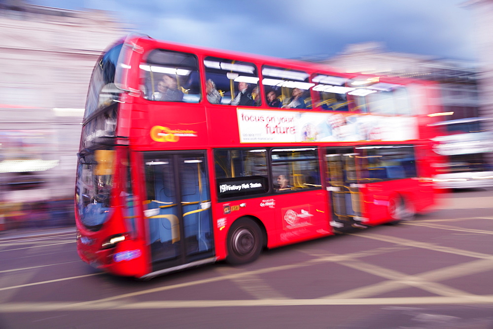 Motion blurred red double decker bus, Piccadilly Circus, London, England, United Kingdom, Europe