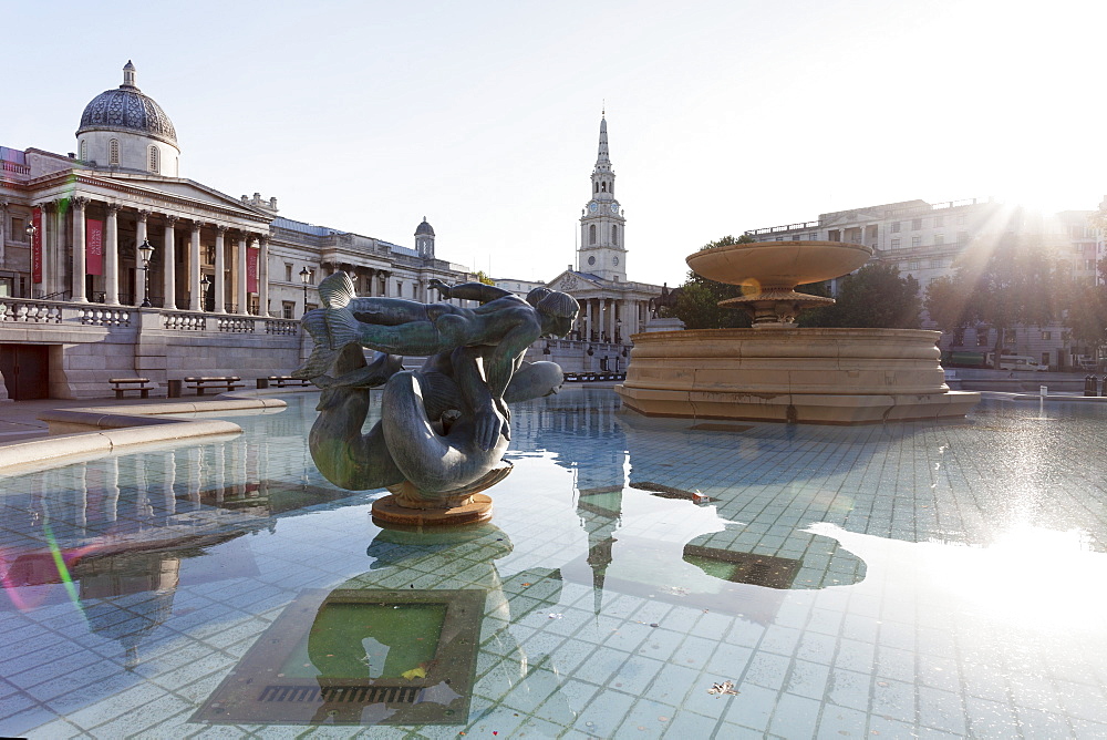 Fountain with statue, National Gallery and St. Martin-in-the-Fields church, Trafalgar Square, London, England, United Kingdom, Europe