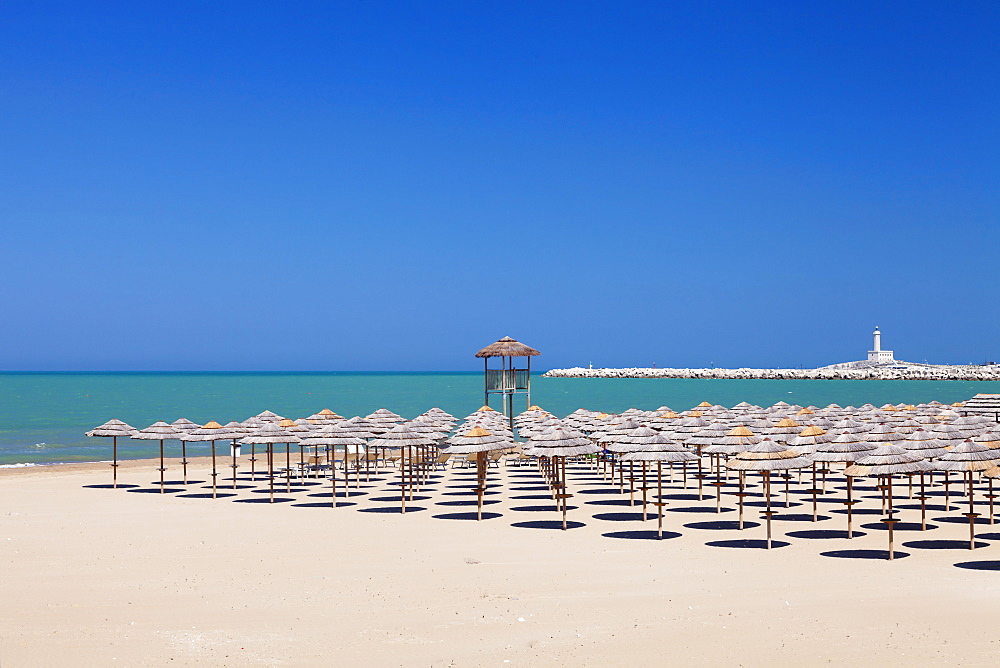 View over Spiaggia di San Lorenzo beach to the lighthouse on Isola di Sant'Eufemia Island, Vieste, Gargano, Foggia Province, Puglia, Italy, Europe