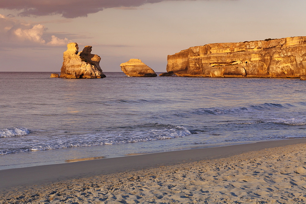 Rocky coast near Torre dell'Orso, Due Sorello Rocks (Two sisters) at sunset, Adriatic Sea, Lecce province, Salentine Peninsula, Puglia, Italy, Mediterranean, Europe