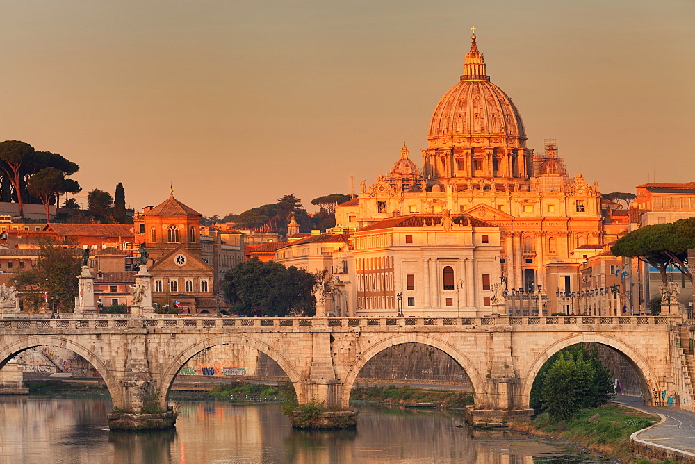 View over Tiber River to Ponte Vittorio Emanuele II Bridge and St. Peter's Basilica at sunrise, Rome, Lazio, Italy, Europe