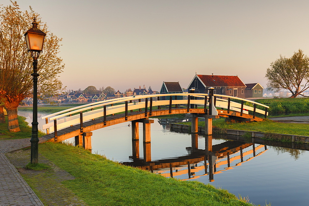 Wooden bridge over Zaan River at sunrsie, open-air museum, Zaanse Schans, Zaandam, North Holland, Netherlands, Europe