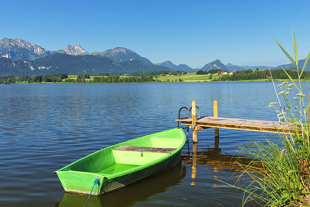 Rowing boat at a jetty, Hopfensee lake, Hopfen am See, Allgau Alps, Allgau, Schwaben, Bavaria, Germany, Europe