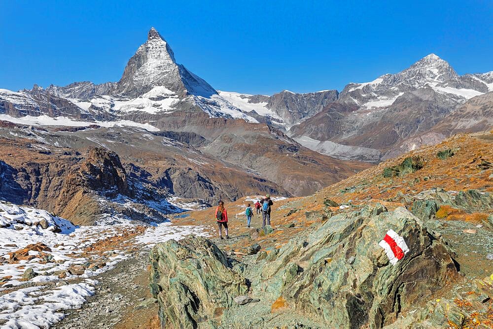 Hikers on Gornergrat, Matterhorn Peak (4478m), Swiss Alps, Zermatt, Valais, Switzerland