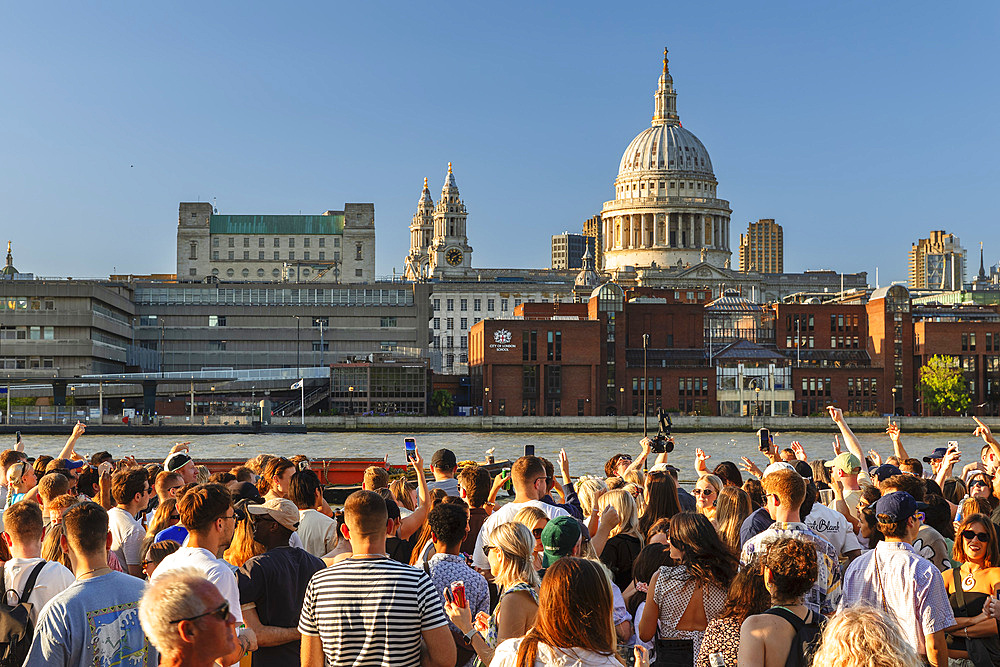 People enjoying a summer evening at Bankside, London, England