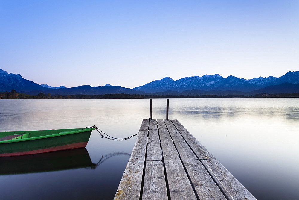 Rowing boat on Hopfensee Lake at sunset, near Fussen, Allgau, Allgau Alps, Bavaria, Germany, Europe