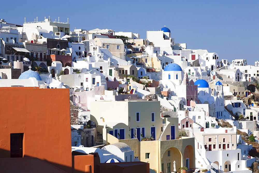 Coloured houses and church with blue dome in the evening light, Oia, Santorini, Cyclades, Aegean Sea, Greek Islands, Greece, Europe 