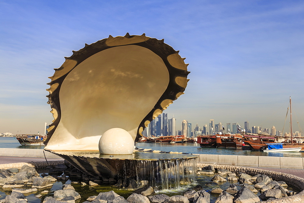 Pearl Monument with moored dhows and modern city skyline of West Bay, from Al-Corniche, Doha, Qatar, Middle East