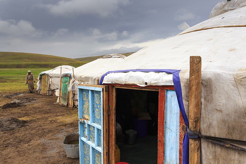 Gers at a Summer nomad camp under dark skies with nomadic man wearing deel, Khujirt, Uvurkhangai (Ovorkhangai), Central Mongolia, Central Asia, Asia