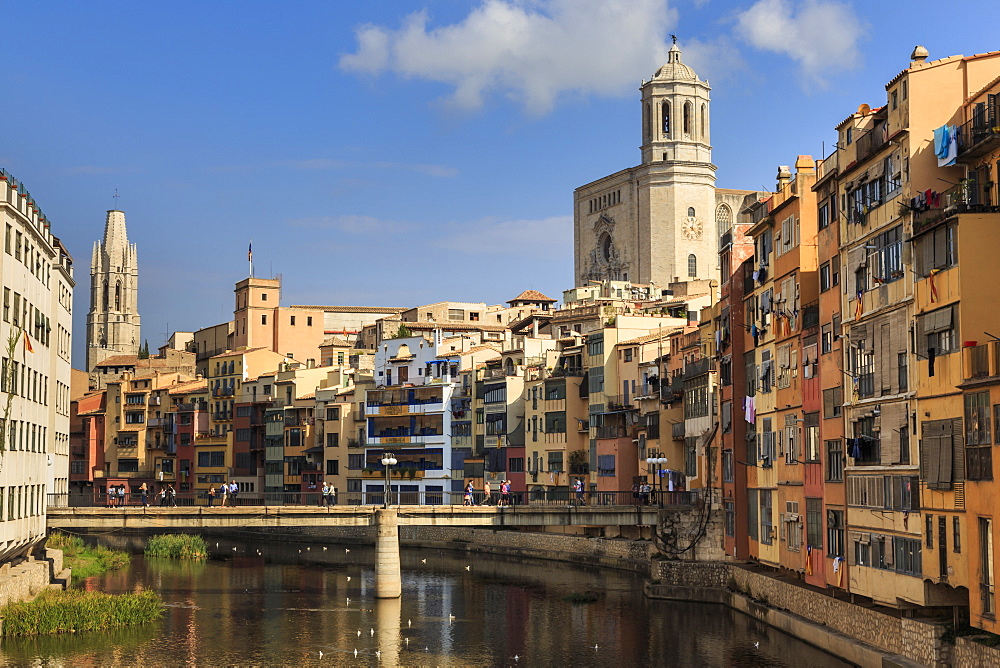 Cathedral towers above distinctive historic colourful arcaded houses and Onyar River, Girona, Girona Province, Catalonia, Spain, Europe