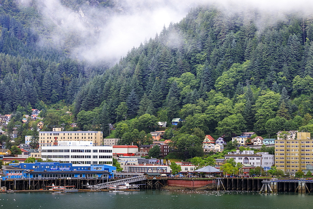 Juneau, State Capital, view from the sea, mist clears over downtown buildings, mountains, forest and float planes, Alaksa, United States of America, North America