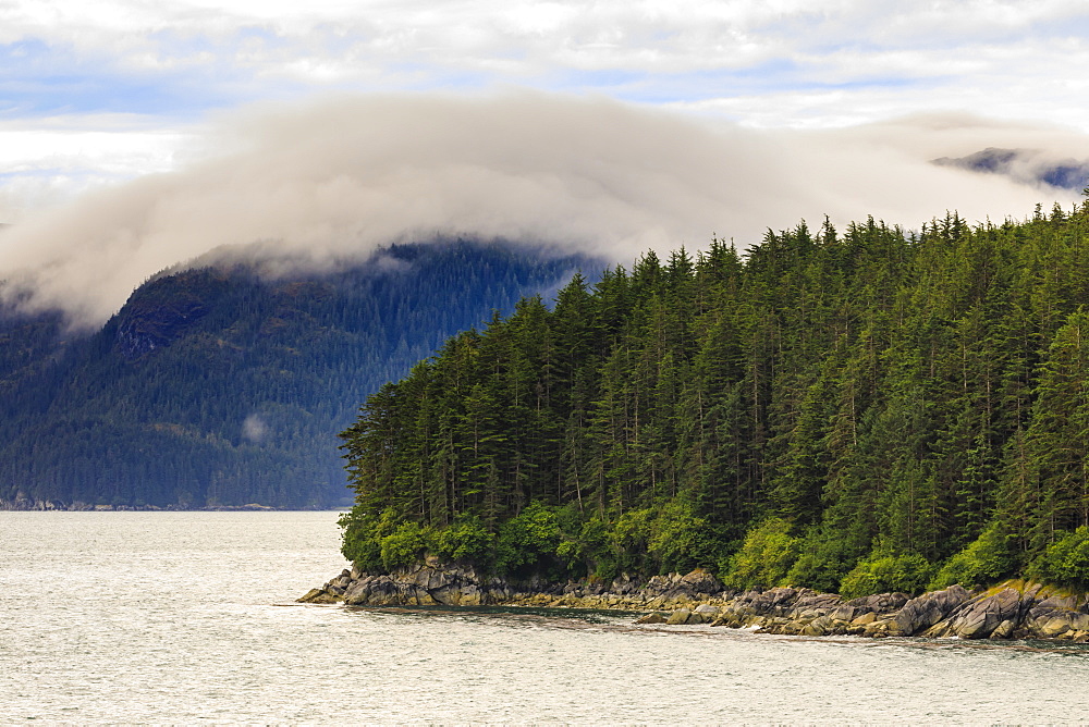 Mist, rocky shoreline and forest, Inian Islands, Icy Strait, between Chichagof Island and Glacier Bay National Park, Alaska, United States of America, North America