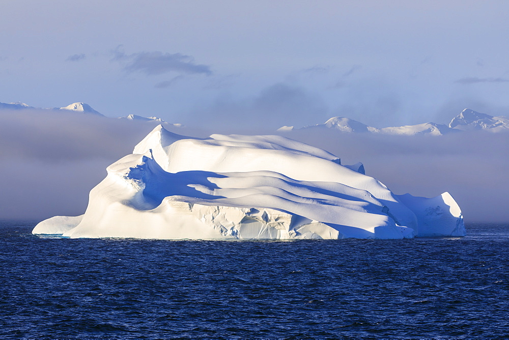 Huge iceberg, evening light, clearing mist, Bransfield Strait, near South Shetland Islands and Antarctic Peninsula, Antarctica, Polar Regions