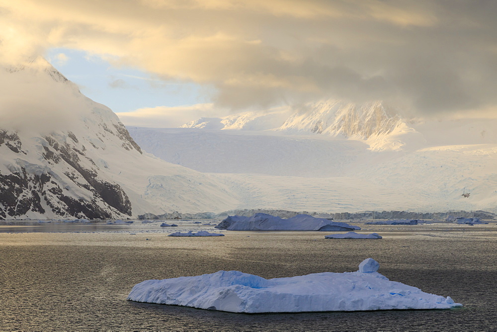 Sunrise, with atmospheric cloud and mist, mountains, glaciers and icebergs, Neko Harbour, Andvord Bay, Graham Land, Antarctica, Polar Regions