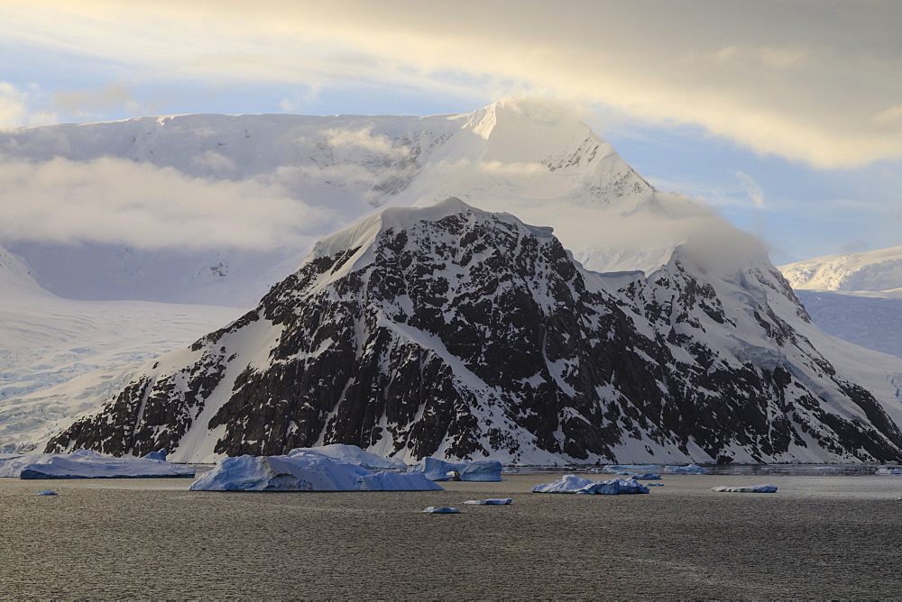 Sunrise, with atmospheric cloud and mist, mountains, glaciers and icebergs, Neko Harbour, Andvord Bay, Graham Land, Antarctica, Polar Regions