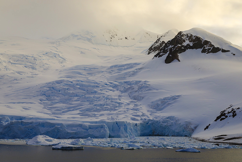 Glacier at sunrise, with atmospheric cloud and mist, Neko Harbour, Andvord Bay, Graham Land, Antarctica, Polar Regions