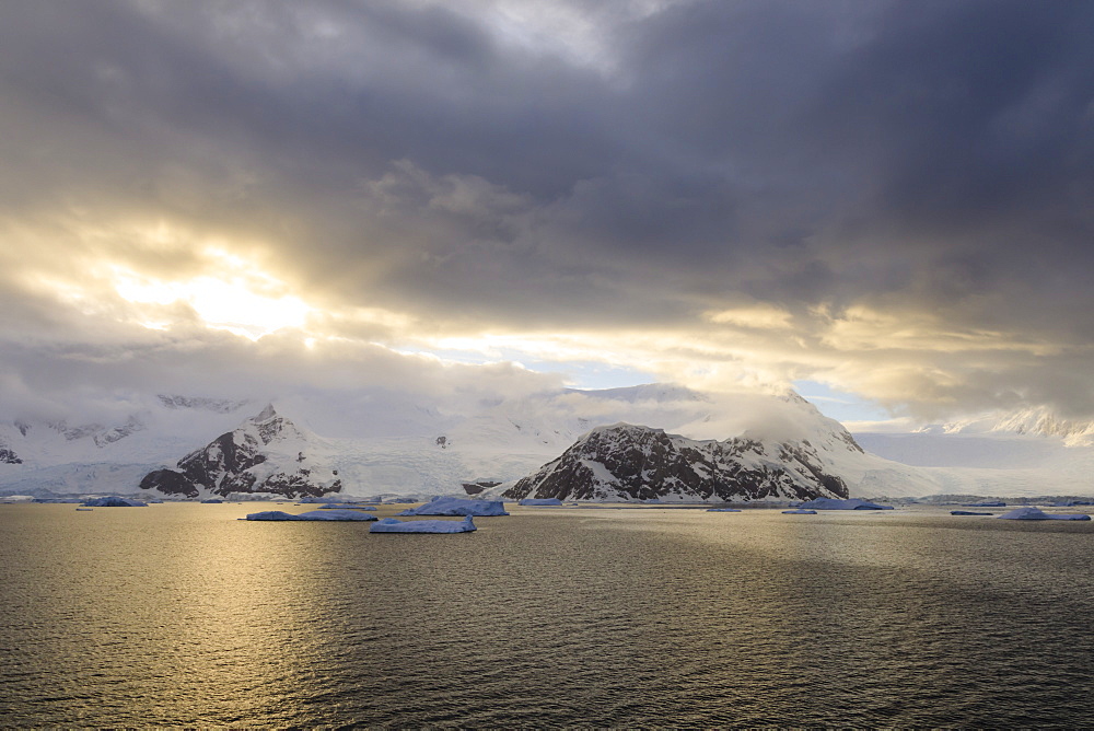 Sunrise, with atmospheric cloud and mist, mountains, glaciers and icebergs, Neko Harbour, Andvord Bay, Graham Land, Antarctica, Polar Regions