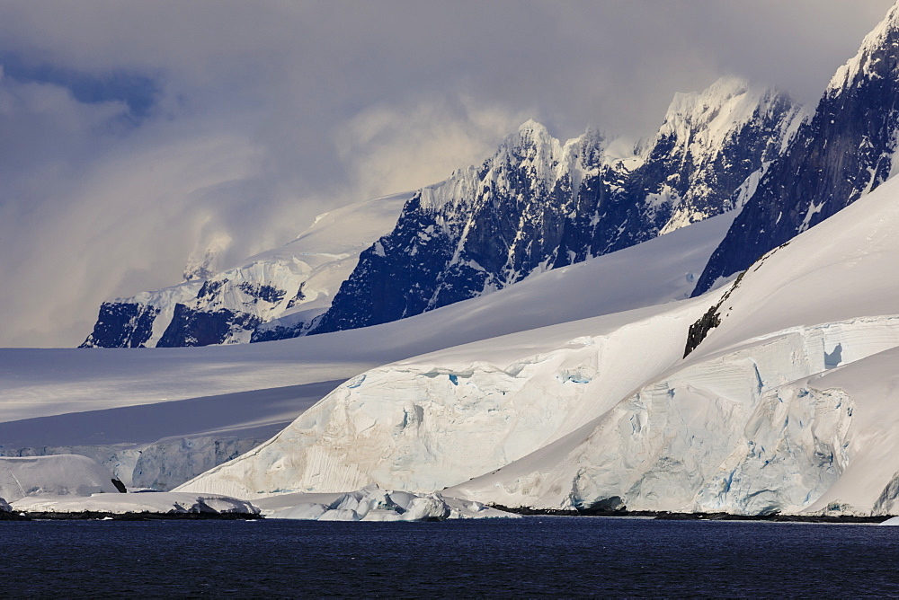 Glaciers, mountain peaks and dramatic clouds and sky, Cape Errera, Wiencke Island, Antarctic Peninsula, Antarctica, Polar Regions