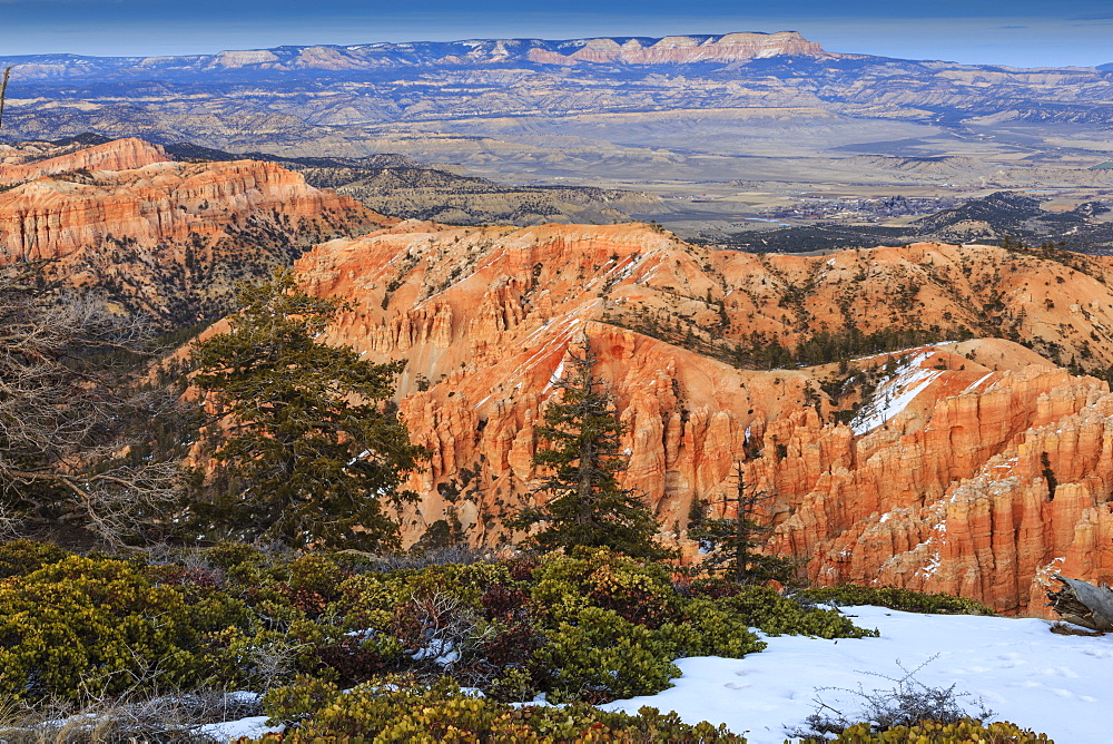 Hoodoos, vegetation and snow with a distant view on a winter's late afternoon, Bryce Point, Bryce Canyon National Park, Utah, United States of America, North America