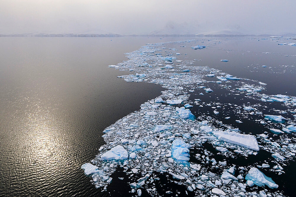 Sun shines through the mist, icy Neumayer Channel between Anvers Island and Wiencke Island, Antarctic Peninsula, Antarctica, Polar Regions