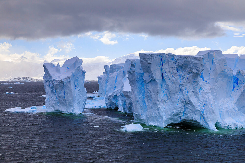 Large blue tabular iceberg and coast of Errera Channel, Danco Coast, Antarctic Peninsula, Antarctica, Polar Regions