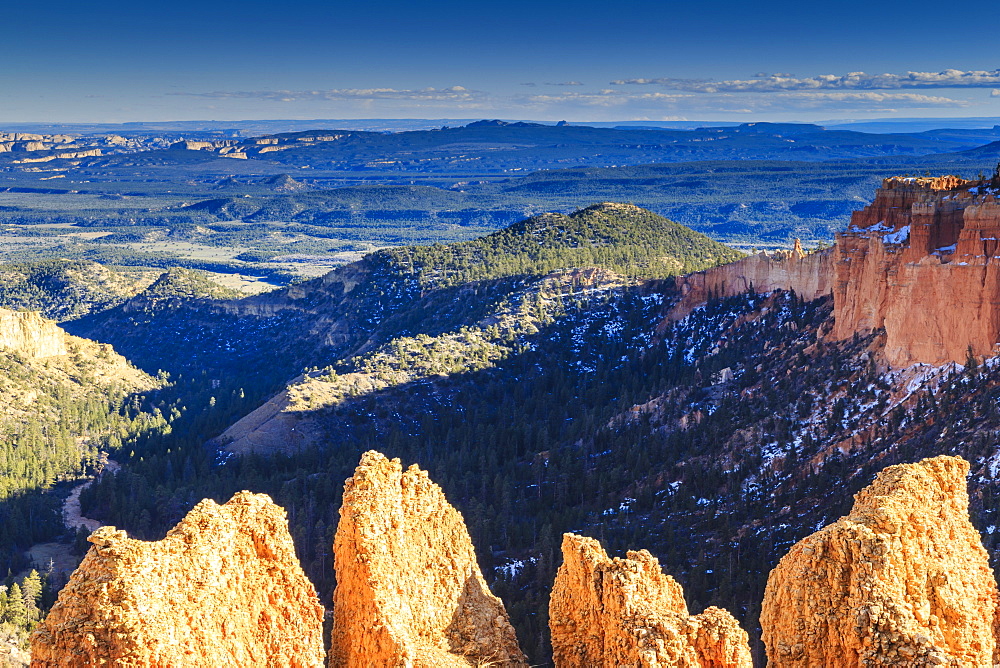 Rocks lit by late afternoon sun with distant view in winter, Paria View, Bryce Canyon National Park, Utah, United States of America, North America