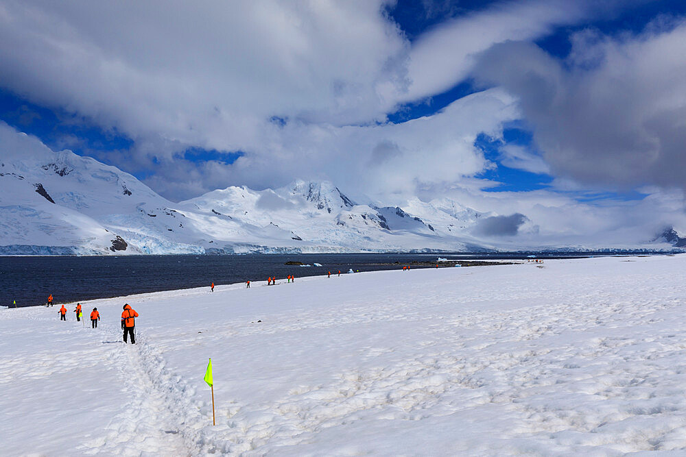 Expedition tourists follow a marked route on Half Moon Island, view to Livingston Island, South Shetland Islands, Antarctica, Polar Regions