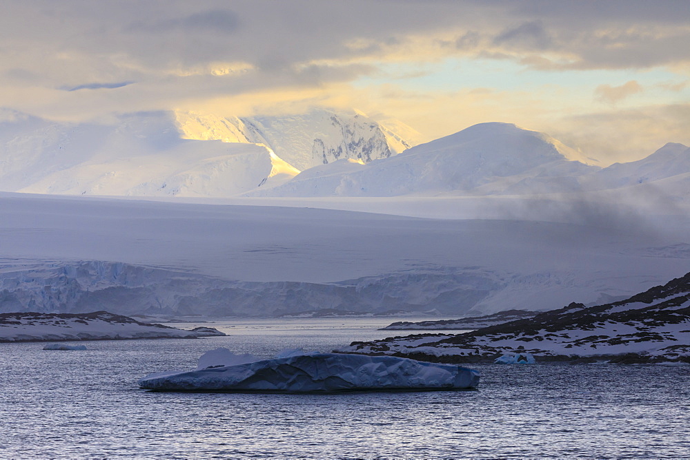 Sunrise, over misty mountains and tidewater glaciers, Anvers Island, Antarctic Peninsula, Antarctica, Polar Regions