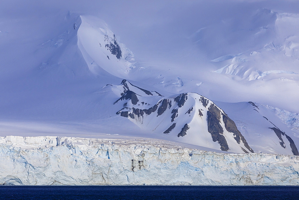 Glacier covered mountains of Greenwich Island, from the sea, bright yet misty weather, South Shetland Islands, Antarctica, Polar Regions