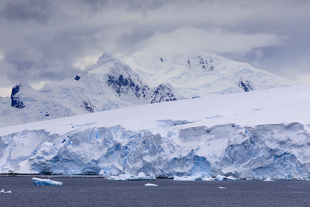 Low lying clouds over the mountains and blue glaciers of Paradise Bay, Antarctic Peninsula, Antarctica, Polar Regions