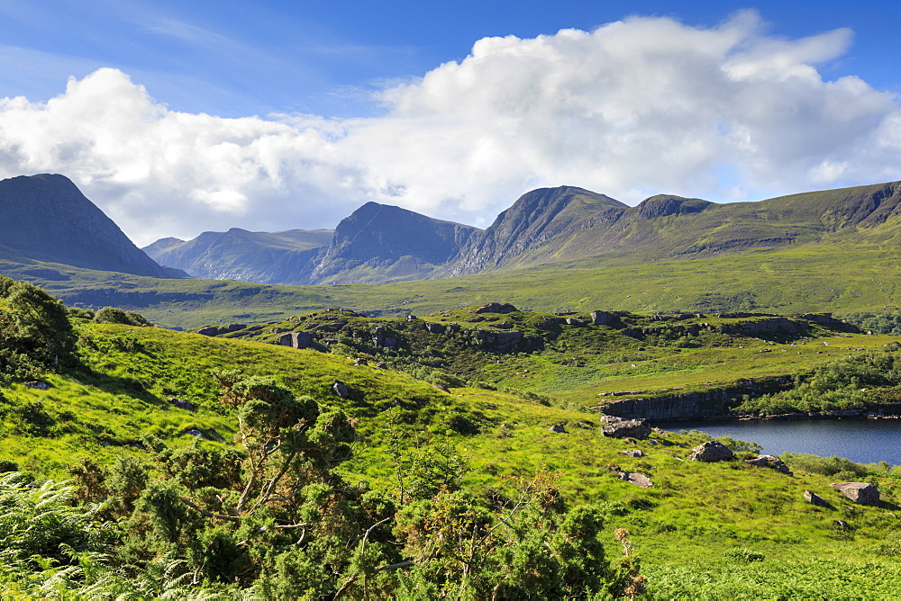 Mountains by fields in Coigach, Scotland, Europe