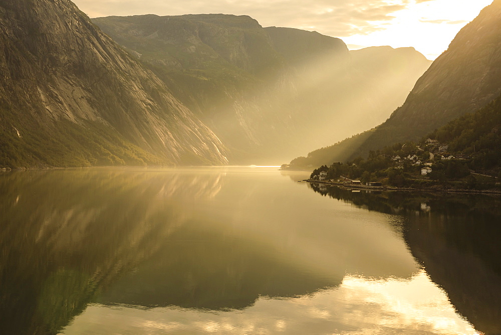 Shafts of light enter misty, beautiful Eidfjord, fjord reflections, Hardangerfjord, Norwegian Western Fjords, Norway, Scandinavia, Europe