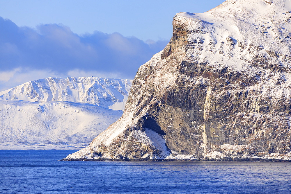 Spectacular snow covered mountains in winter, Troms islands, from the Norwegian Sea, Arctic Circle, North Norway, Europe