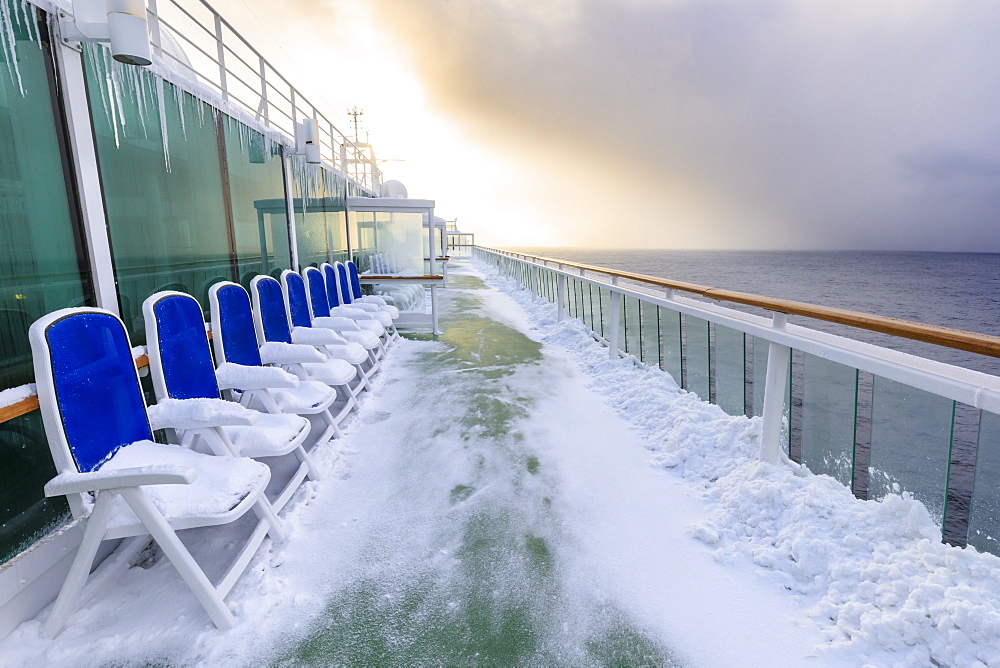 Cruise ship on an Arctic Winter voyage, fresh powder snow on decks, off Troms County, North Norway, Scandinavia, Europe