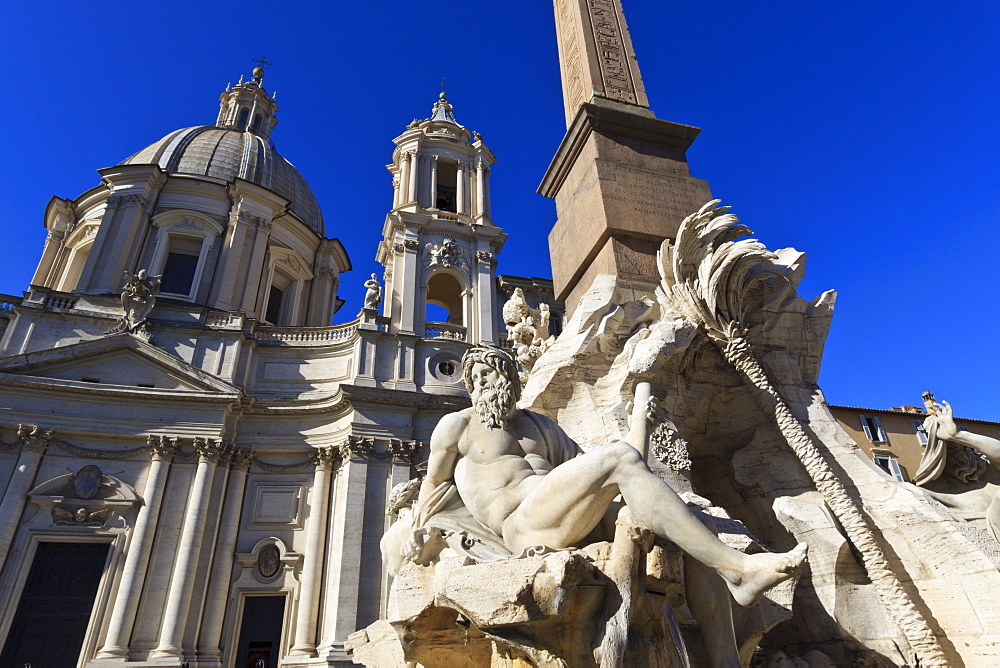 Fontana dei Quattro Fiumi, topped by the Obelisk of Domitian with the Sant'Agnese in Agone, Piazza Navona, Rome, Lazio, Italy, Europe