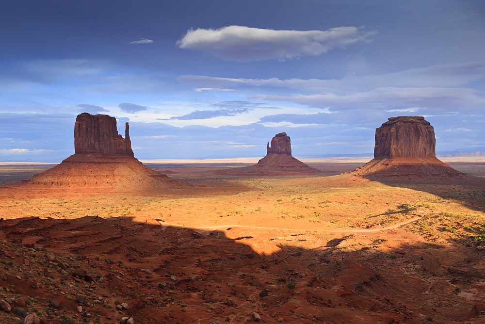 Mittens at dusk, late evening sun lights the desert floor, Monument Valley Navajo Tribal Park, Utah Arizona border, United States of America, North America