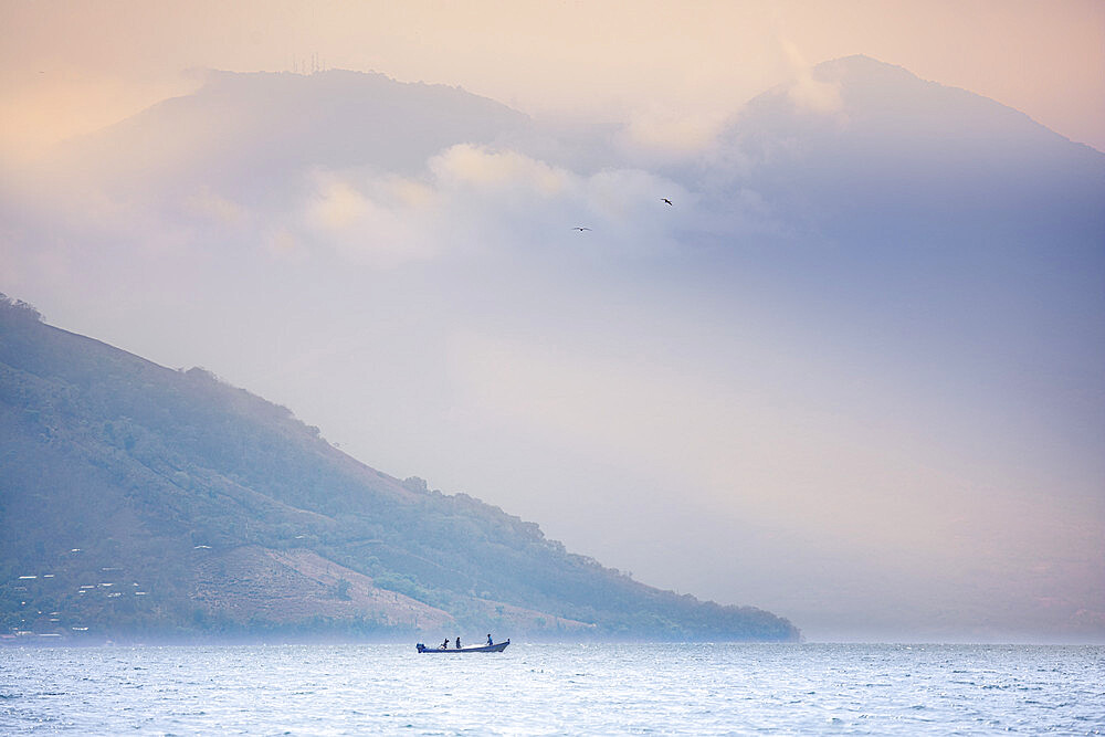 Fishing boat against the looming backdrop of Conchagua Volcano and the Cerro Cacahuatique, Gulf of Fonseca, El Salvador, Central America